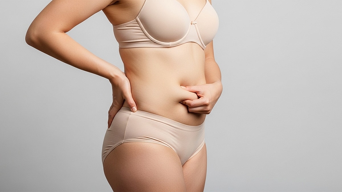 Day by Day Recovery After a Mommy Makeover - Woman in nude lingerie posing against gray background