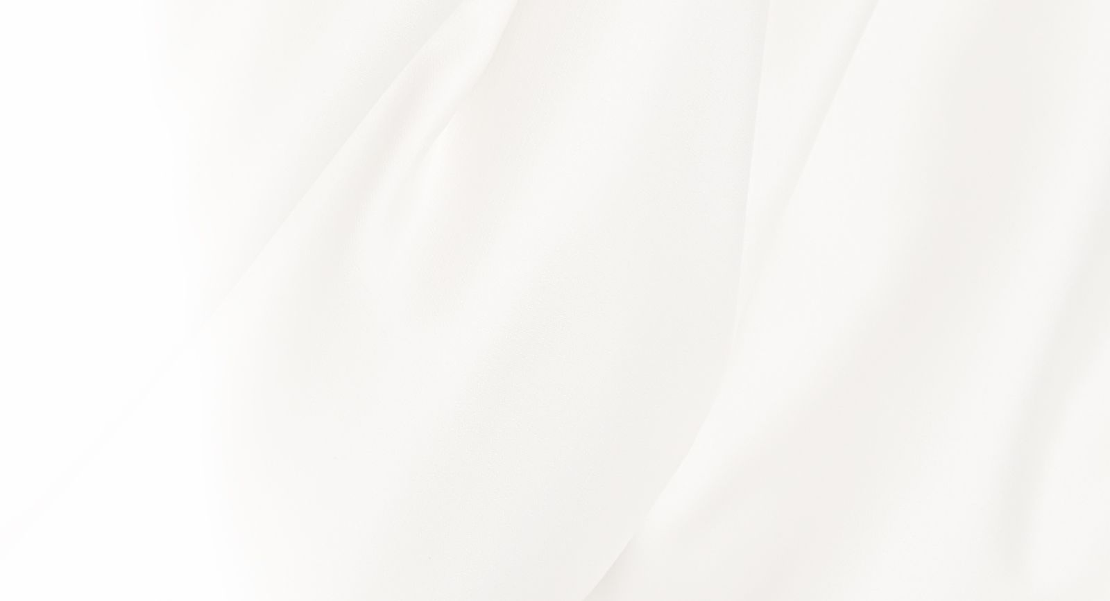 Soft white fabric with gentle folds.