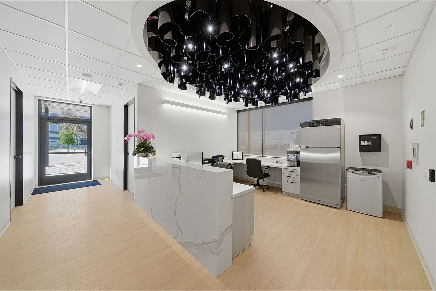 Modern office reception area with stylish ceiling lights.