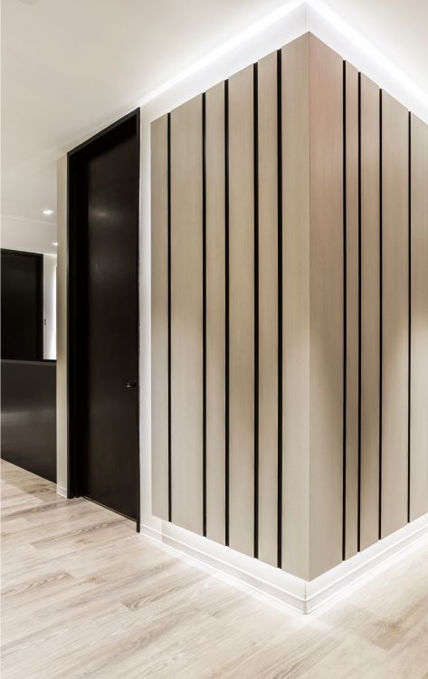 Modern hallway with wooden paneled walls.