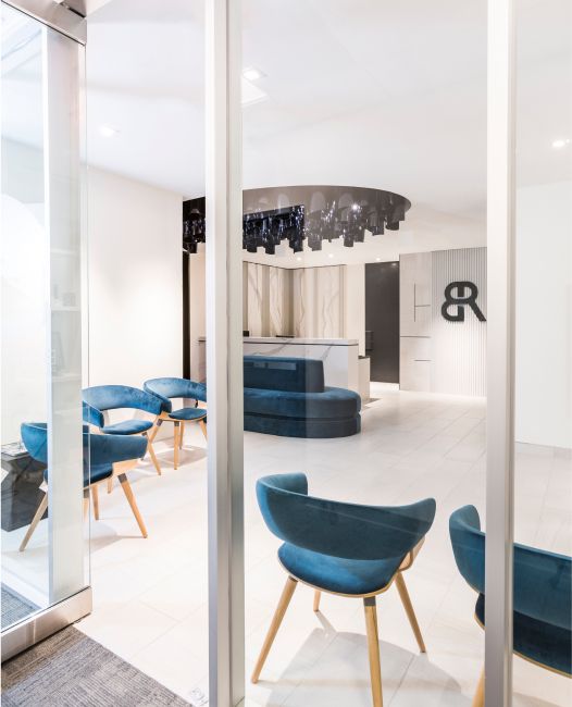 Modern reception area with stylish blue chairs.