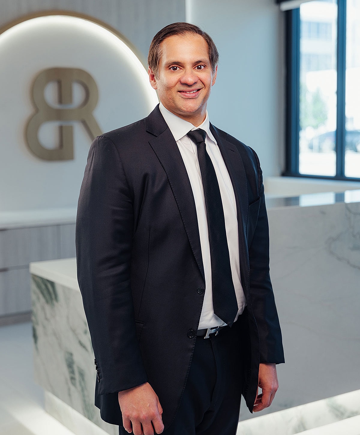 Professional man in suit standing indoors.