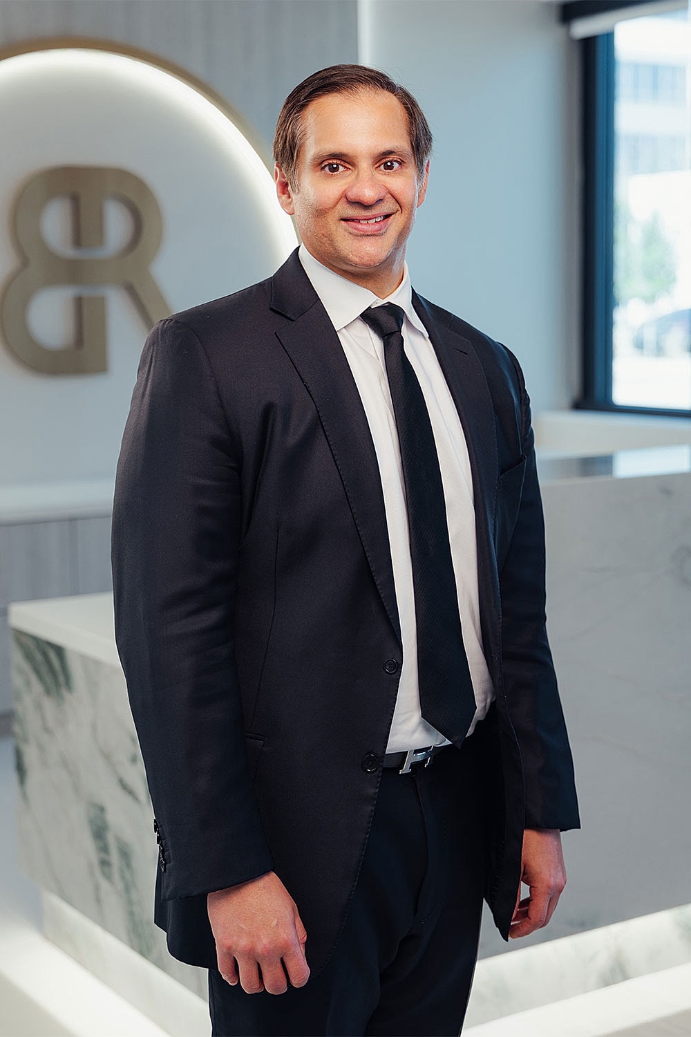 Professional man in suit standing in office.