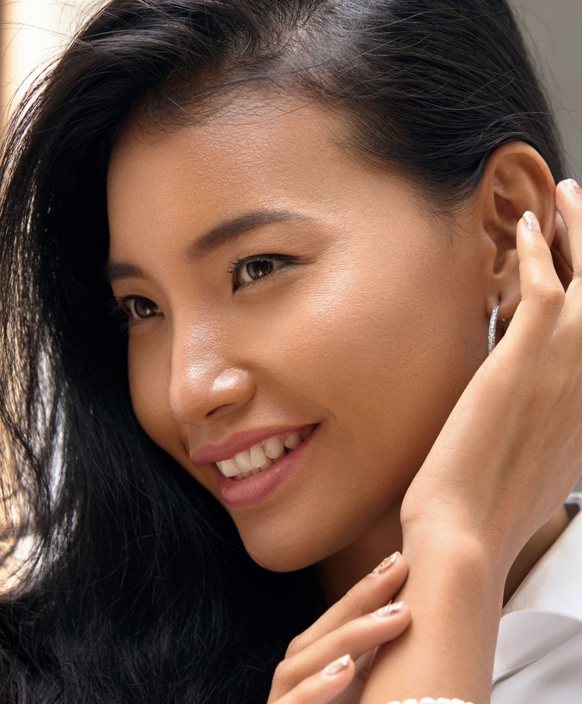 Smiling young woman with long dark hair.