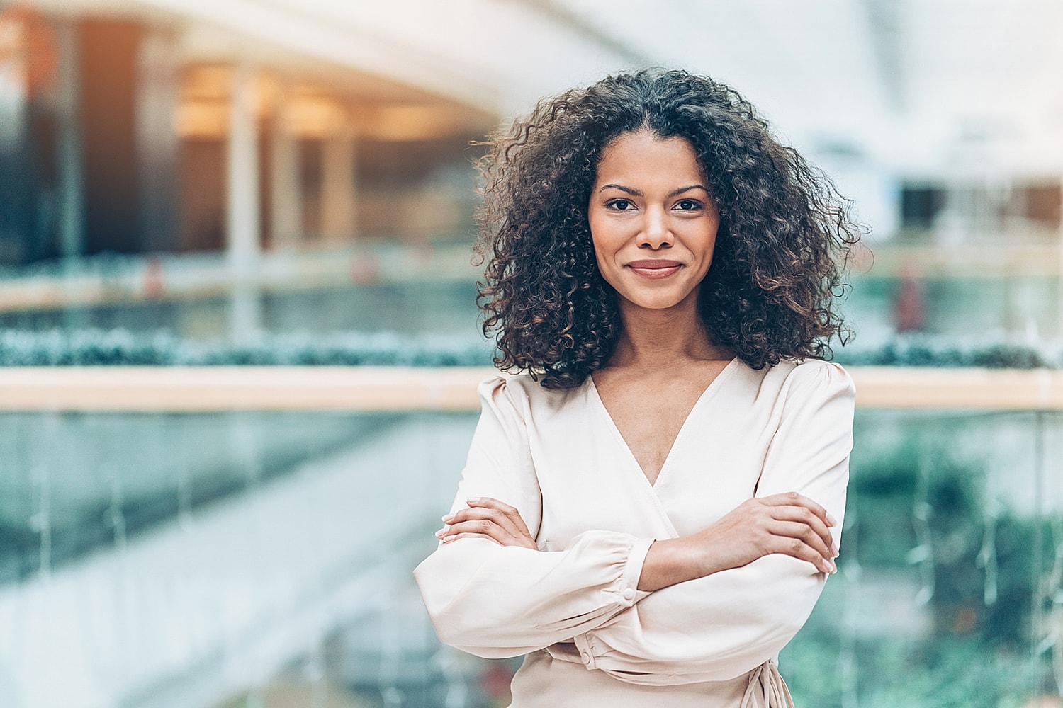 Confident woman smiling in urban setting.