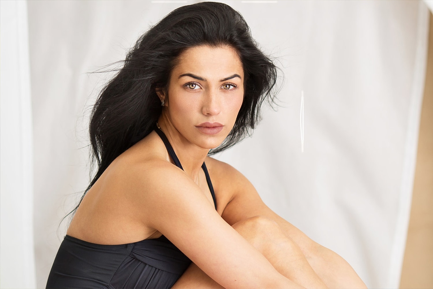 Portrait of a woman with flowing dark hair.