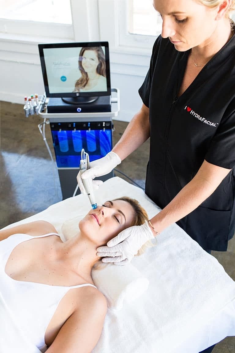 Facial treatment using HydraFacial machine.