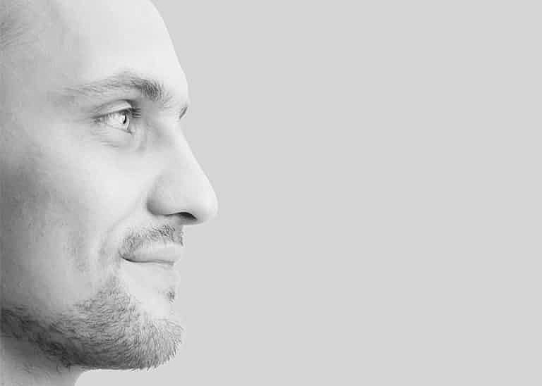 Profile portrait of a smiling man.