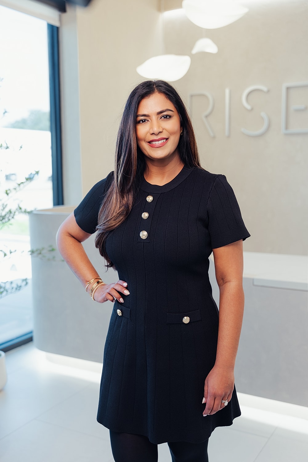 Person smiling in an office setting.