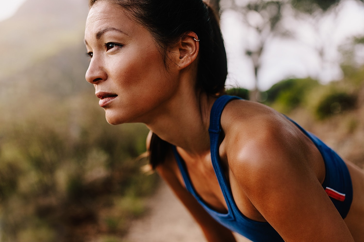 Woman in workout gear, focused and determined.