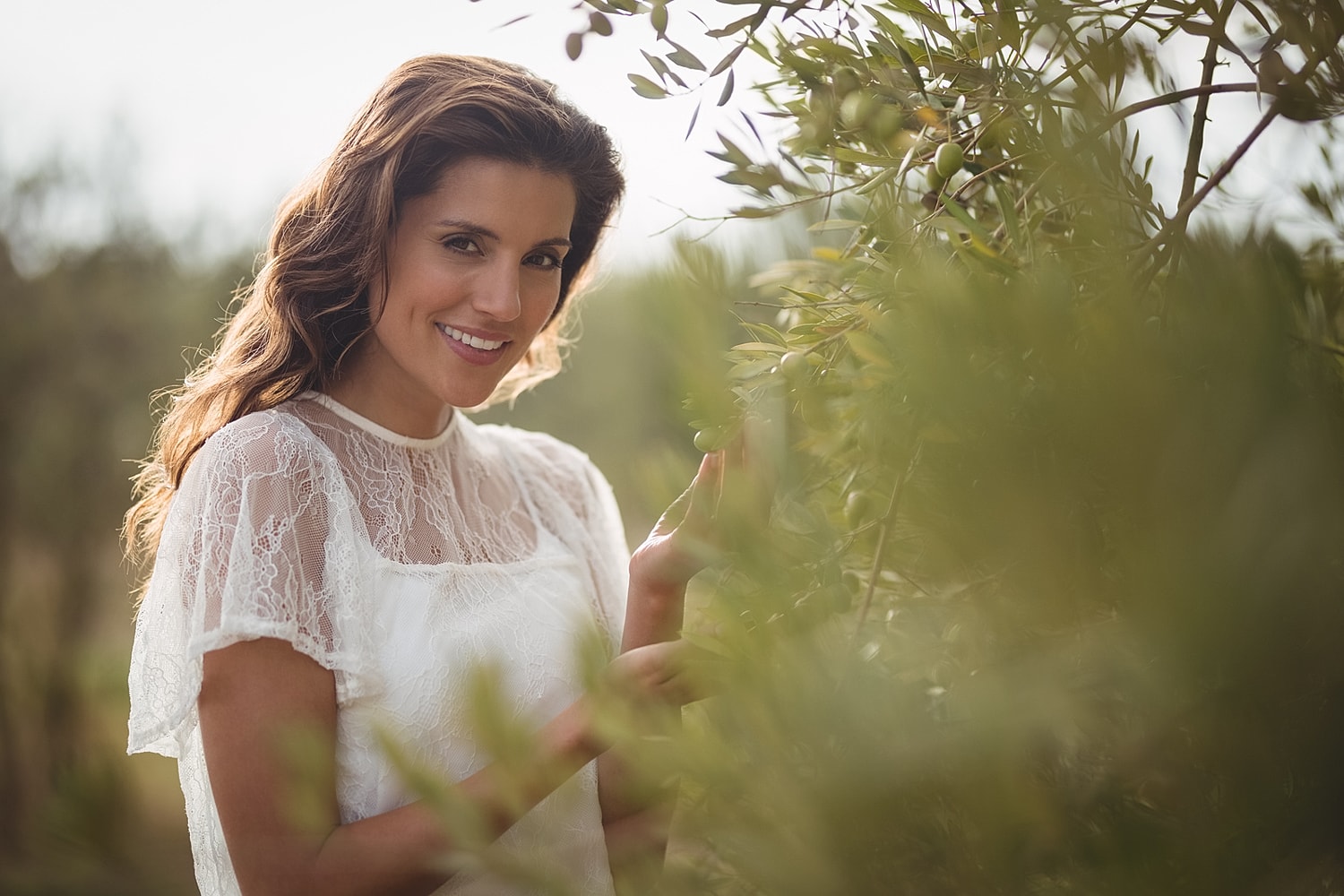 Smiling woman in a garden setting.