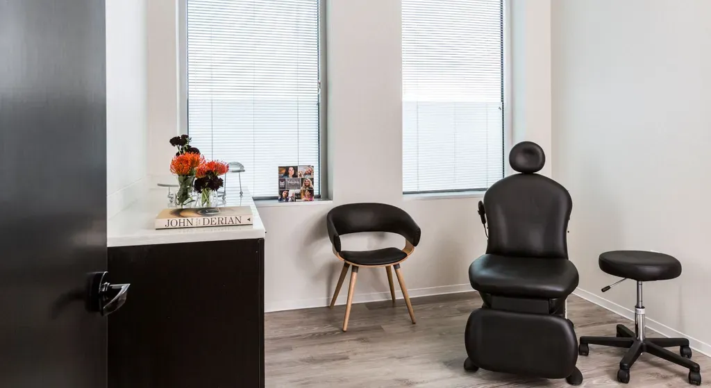Minimalist waiting room with medical chairs and decor.