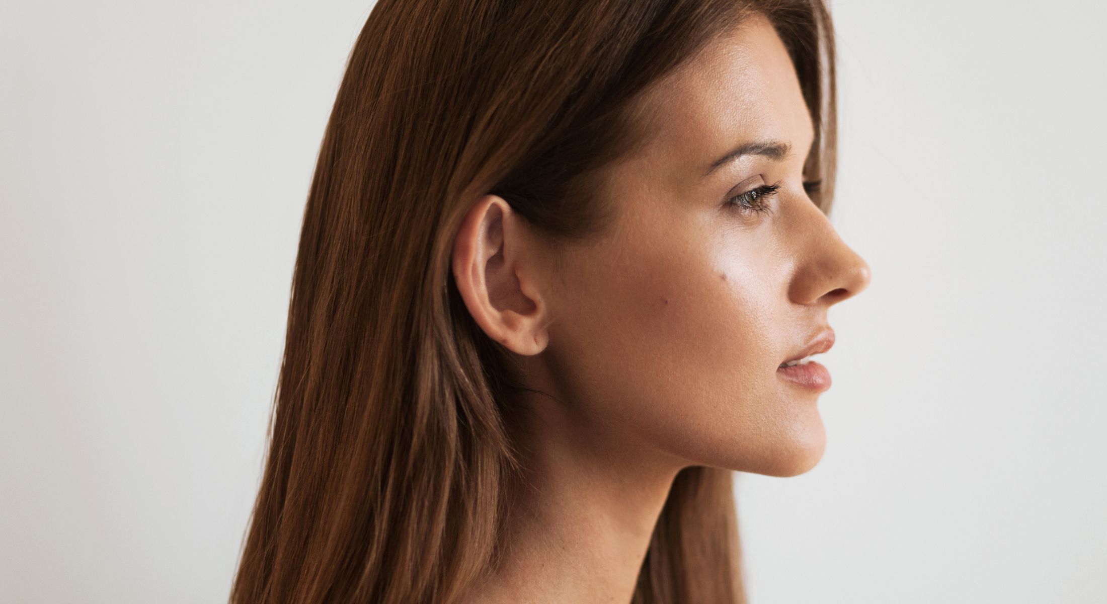 Profile of a Houston mini facelift model with long brown hair.